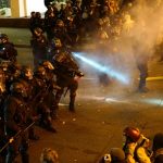 A police officer sprays the crowd with an irritant during a protest against the election of Republican Donald Trump as President of the United States in Portland, Oregon